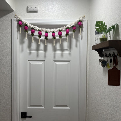 3FT Jasmine & Dark Pink Bud Toran hanging on a wooden front door – handmade Indian Diwali door decoration with white jasmine and sola wood buds