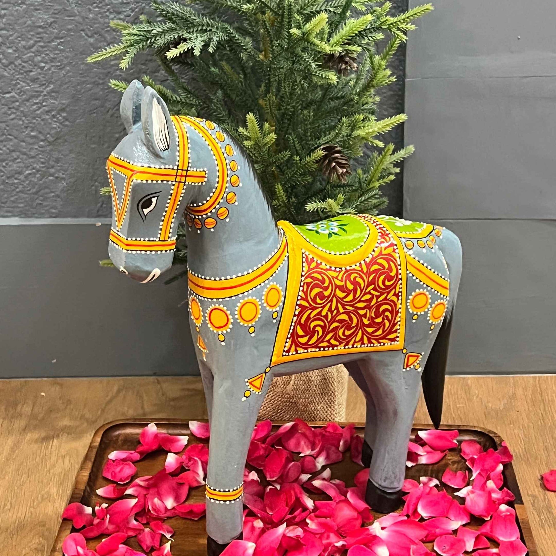 Close-up of the detailed carving on the wooden horse statue.
