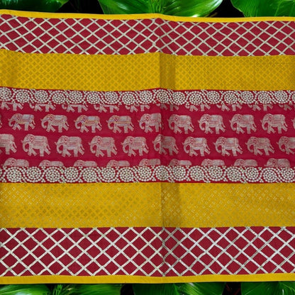 Close-up of silk brocade fabric showing intricate elephant motif and vivid red-yellow color—prayer mat & ethnic runner.