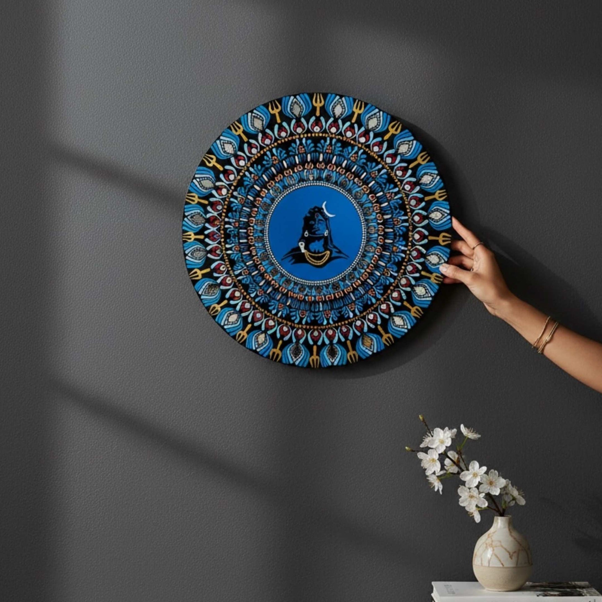 Adiyogi Shiva circular wall art with mandala patterns on a dark wall
