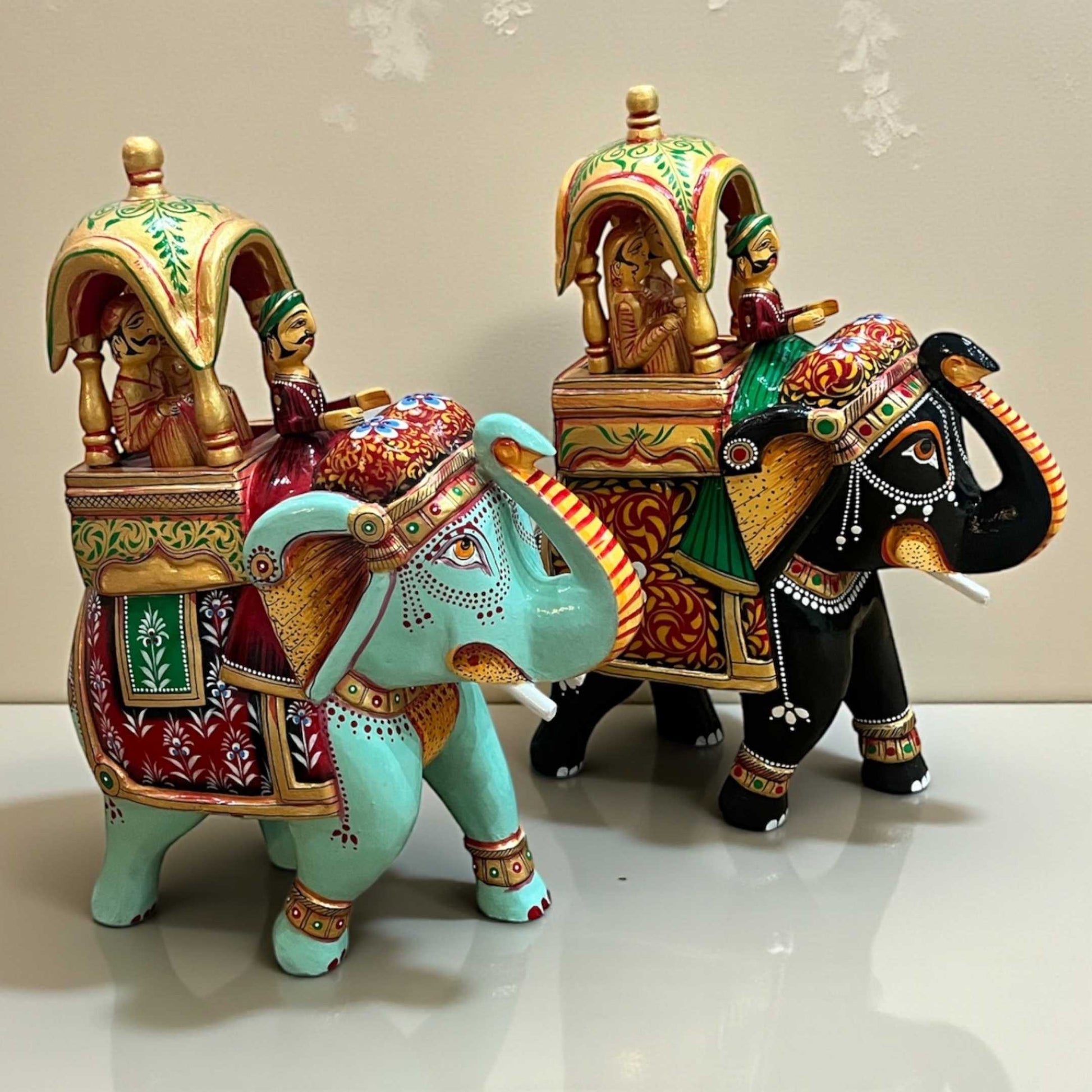 Front-facing Walking Ambabari Elephant wooden decor figurine with fine carved patterns on a light neutral backdrop.