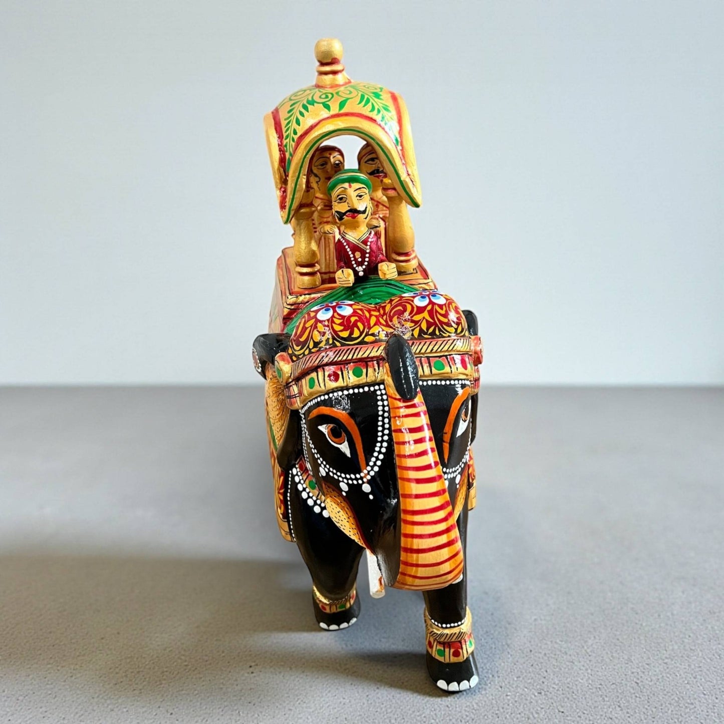 Colorfully detailed Walking Ambabari Elephant statue featuring a detailed carved rider figure mounted atop elephant on a plain background.