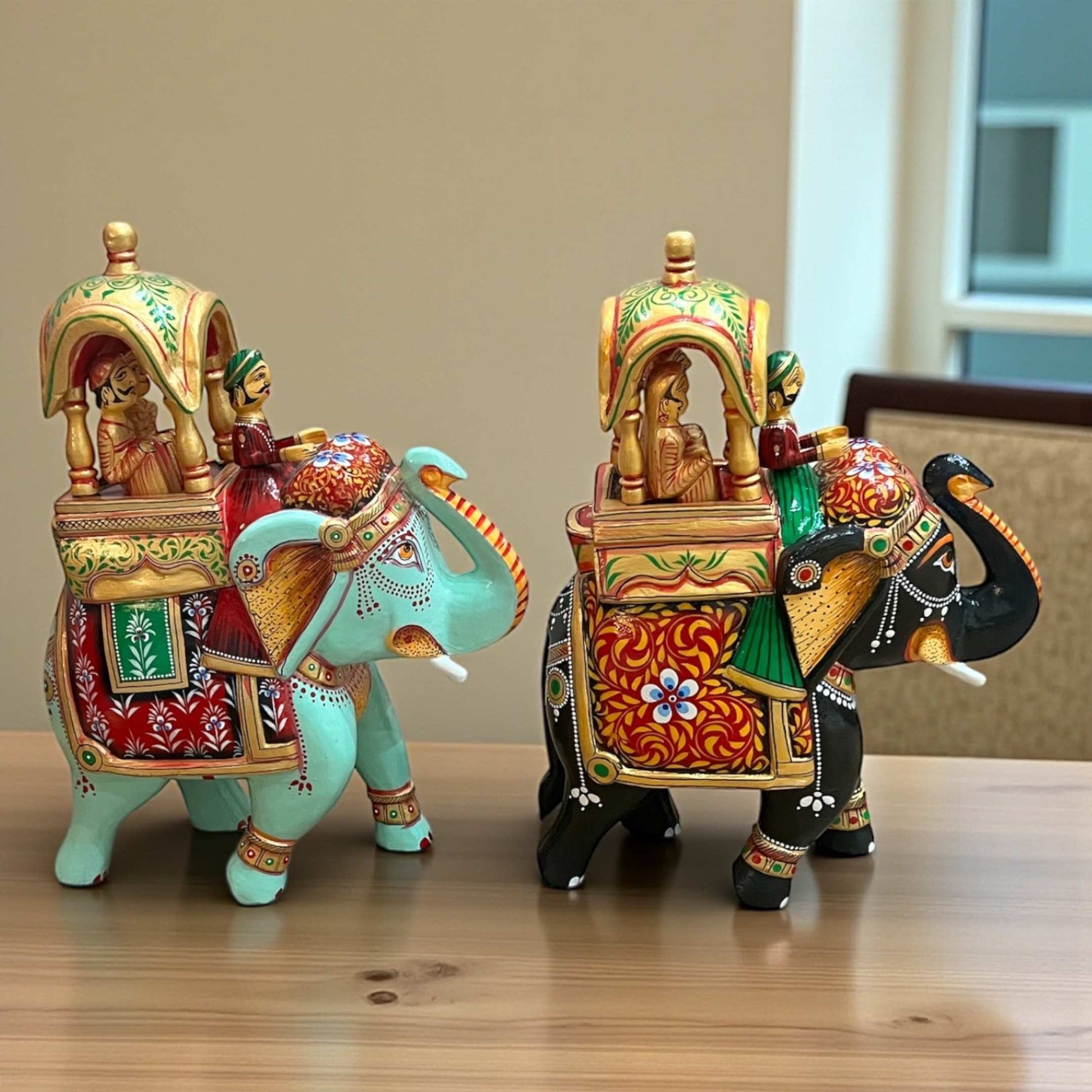 Handcrafted Walking Ambabari Elephant wooden statue with detailed carved patterns, vibrant matte painted finish against blue backdrop, showcasing traditional Indian royal decor.
