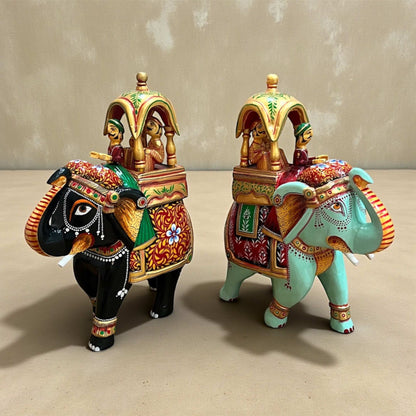 Pair of Walking Ambabari Elephant handpainted wooden decor statues with carved riders, vibrant accents on beige background.