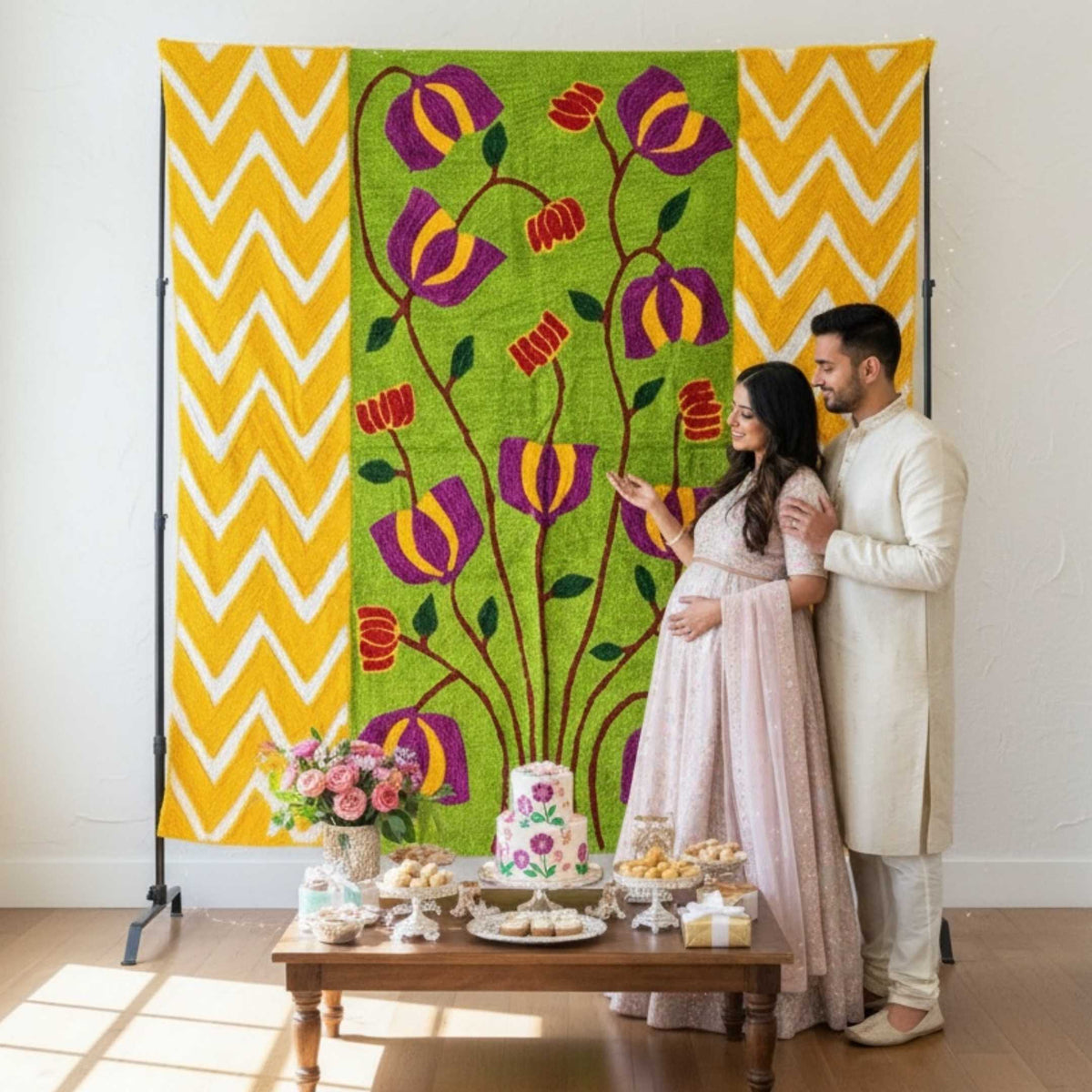 Green lotus flower yarn backdrop with yellow chevron side panels displayed behind a couple at an Indian wedding