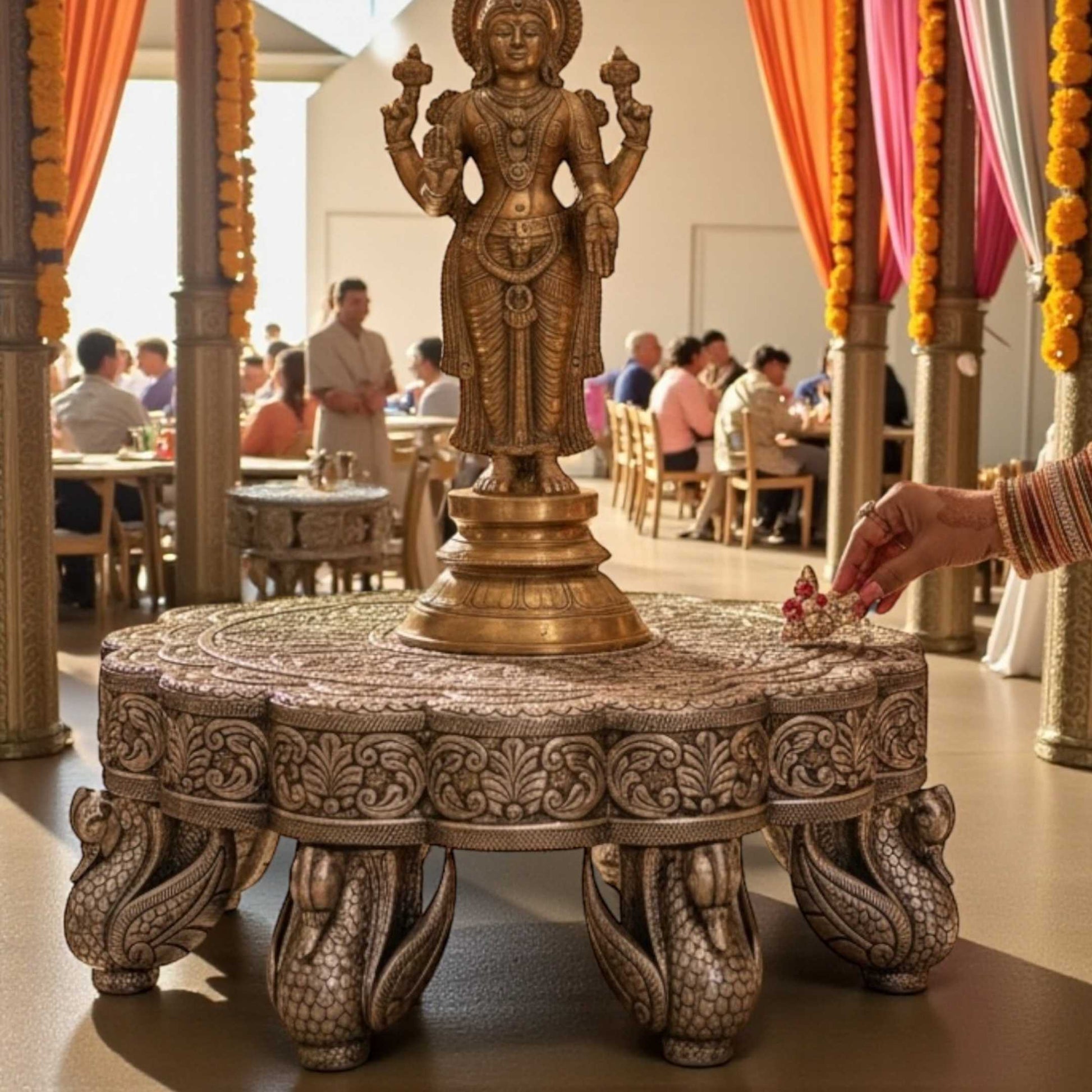 Antique silver pooja chowki used as a pedestal for Hindu deity statues in a home mandir.