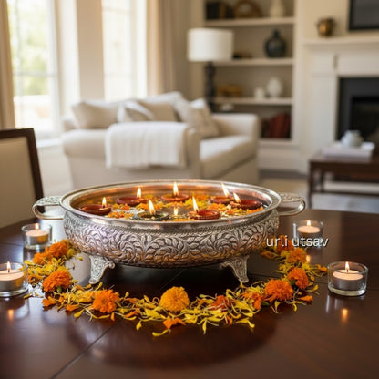 Antique silver urli bowl decorated with floating flowers as festive home decor