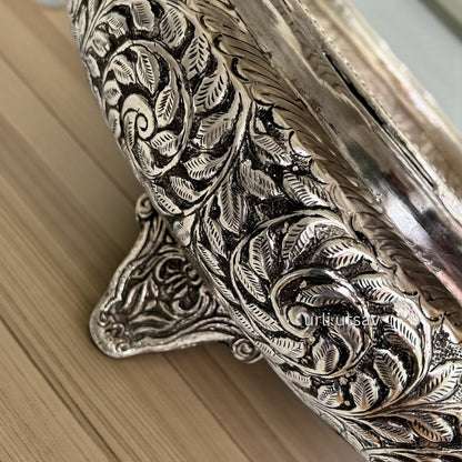 Close up of intricate leaf engraving on silver antique 25 inch urli bowl