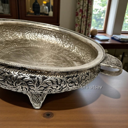 26-Inches Leaves Engraved German Silver Urli Bowl with intricate designs on a wooden surface.