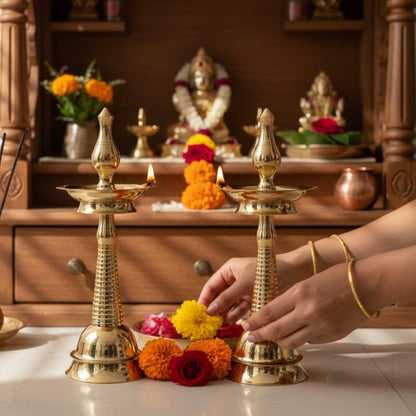 Traditional Indian brass Samai oil lamps styled in a home pooja mandir – Elegant festive decor for housewarming and wedding ceremonies.