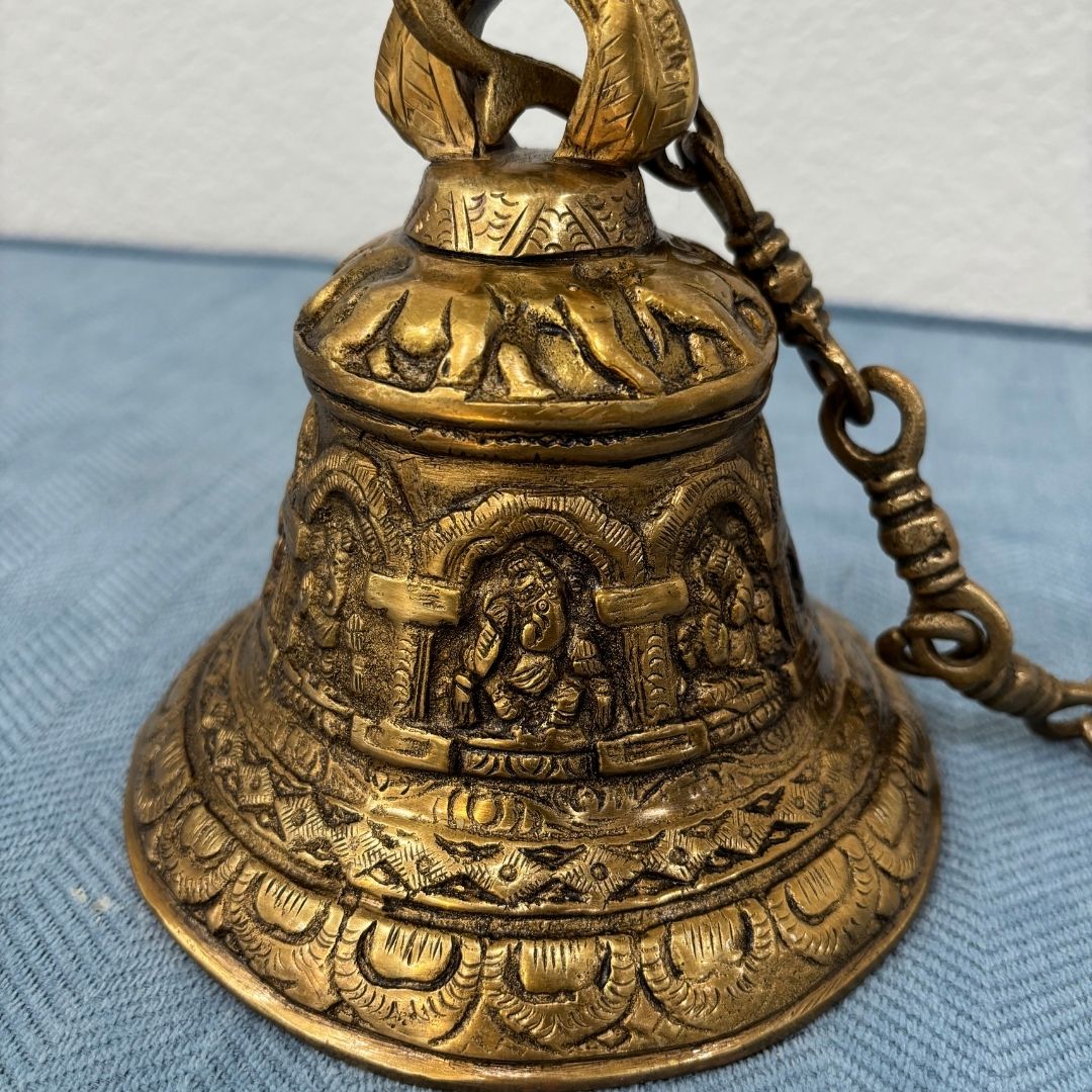 Detailed image showcasing the fine engravings on the brass bell, highlighting traditional Indian craftsmanship