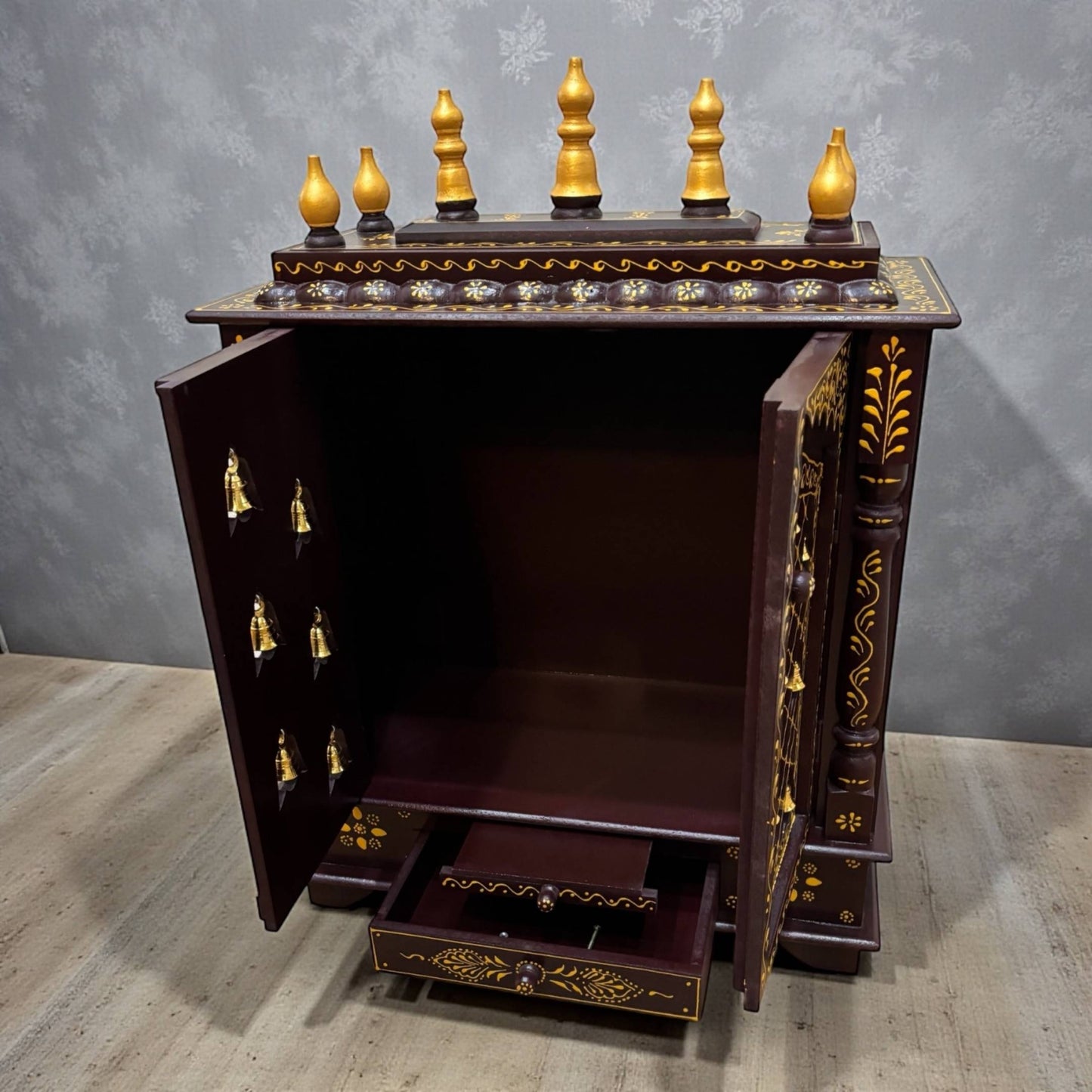 Interior view of brown and gold wooden pooja mandir showing shelf and space for idols