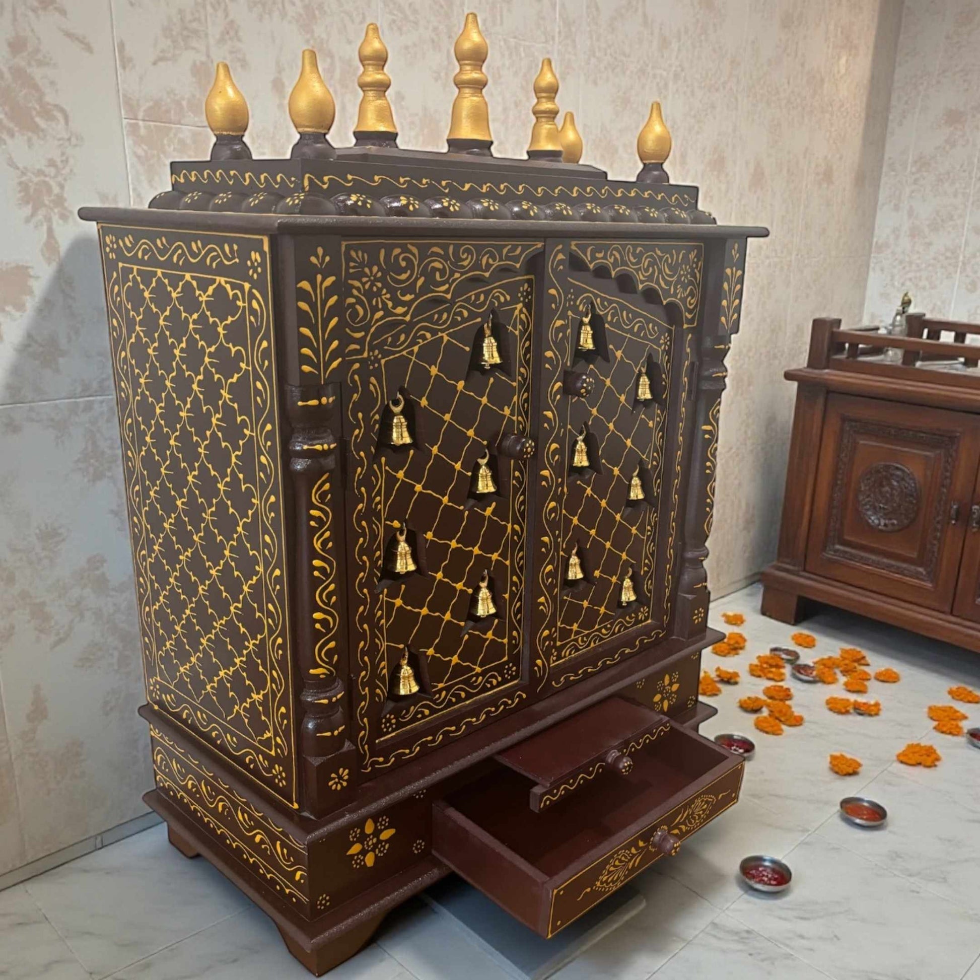 Walnut brown wooden pooja mandir placed in a traditional Indian pooja room setting for daily rituals
