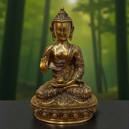 Bronze-toned Buddha statue outdoors with forest background — serene meditation vibe