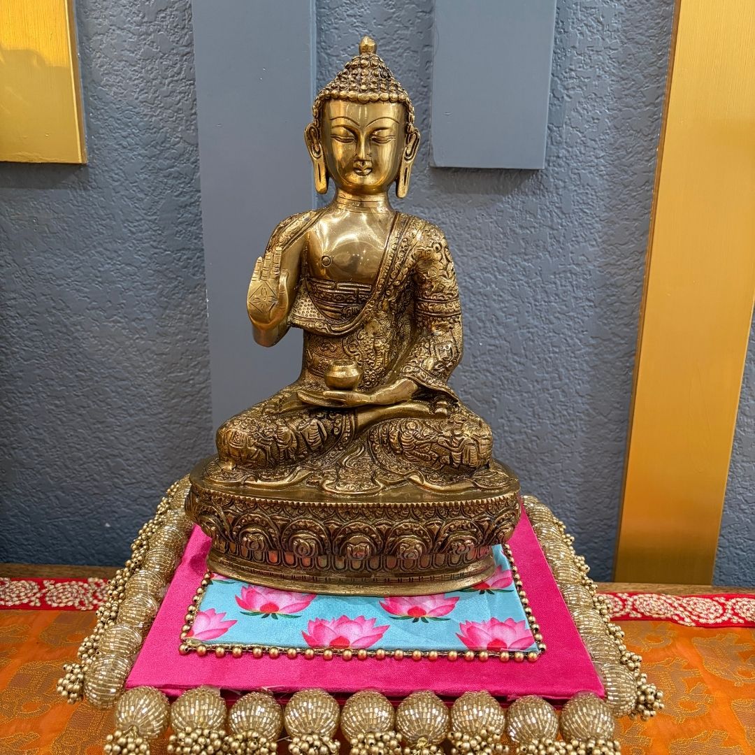 Handcrafted 12" Brass Buddha on decorative platform with blue-pink cushion — meditation decor