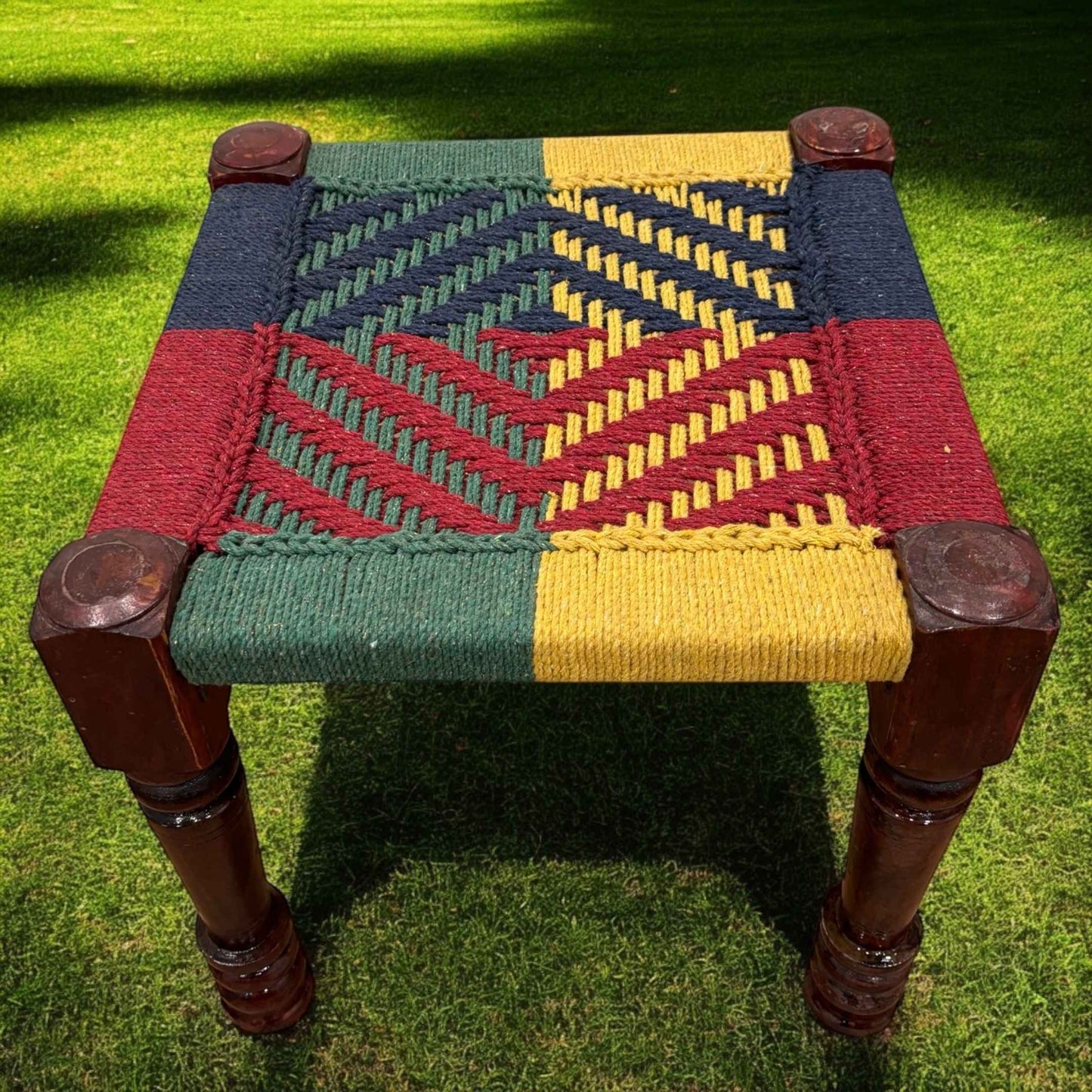 Handwoven charpai rangi stool set styled in a boho living room with rustic decor