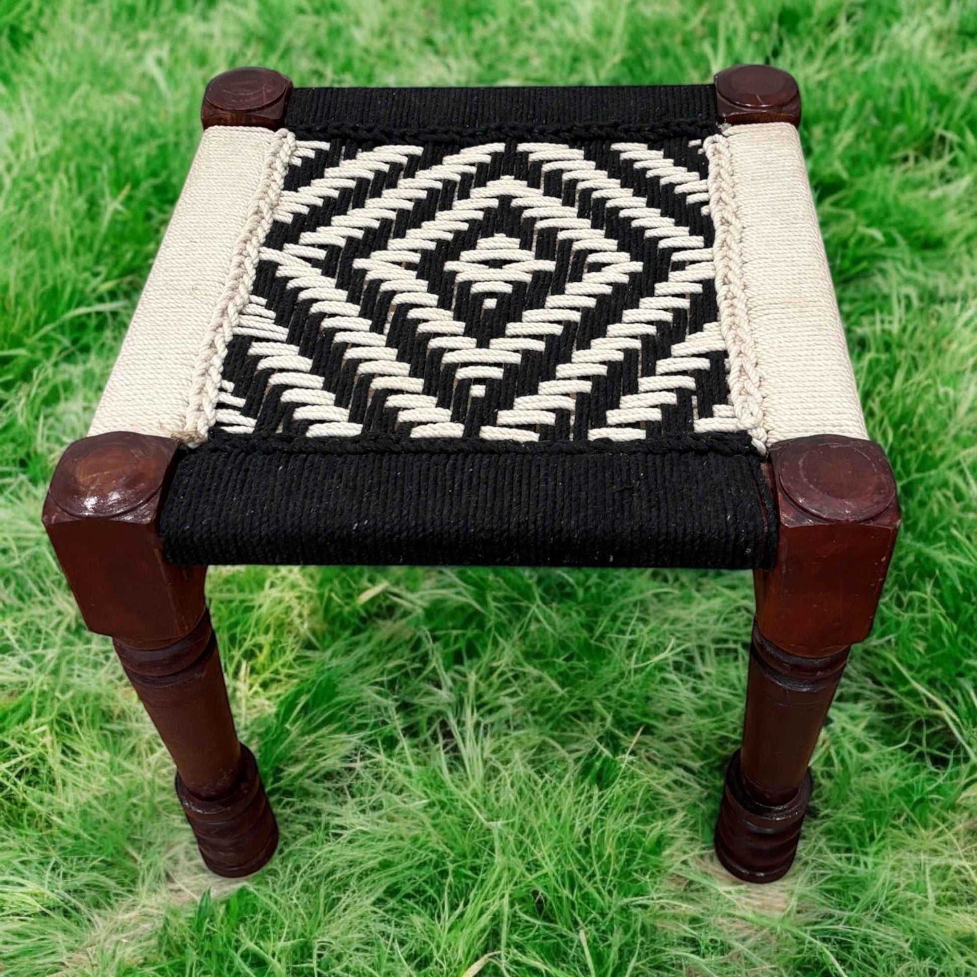 boho low vintage stool in white and black color featuring a woven rope seat - perfect decor element in living room
