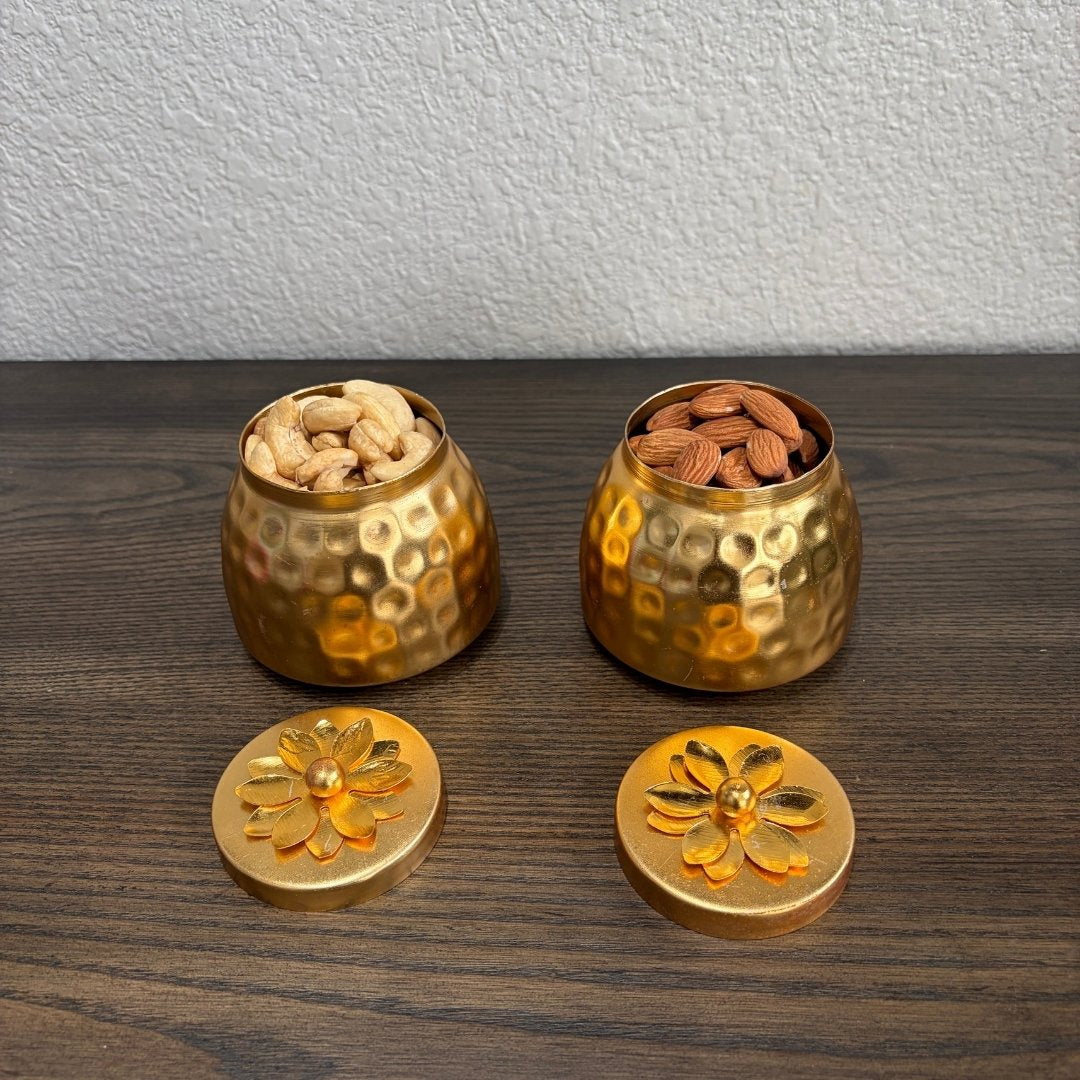 Two copper containers with floral lids, filled with nuts, displayed on wood — copper box set inspiration