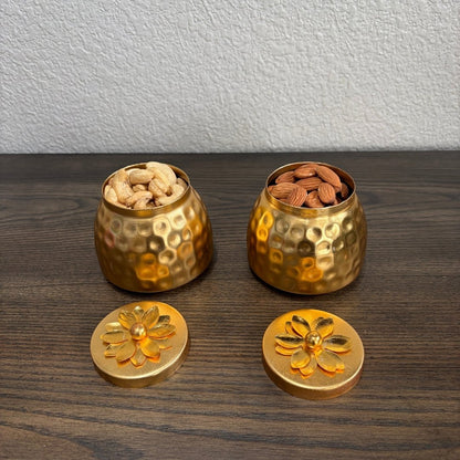 Two copper containers with floral lids, filled with nuts, displayed on wood — copper box set inspiration