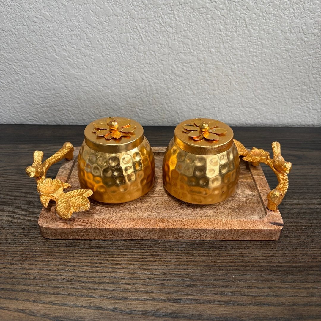 Two copper‑coated jars with ornate lids placed on wooden tray — elegant Indian gift hamper
