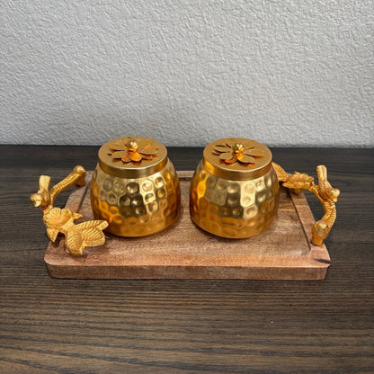 Two copper‑coated jars with ornate lids placed on wooden tray — elegant Indian gift hamper