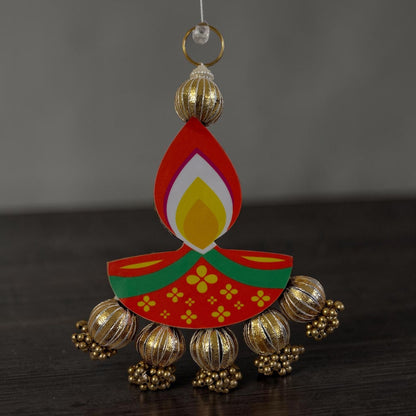 Short diya dangler close-up — colorful MDF Diya cutout with large gold jhumka bells and bead string