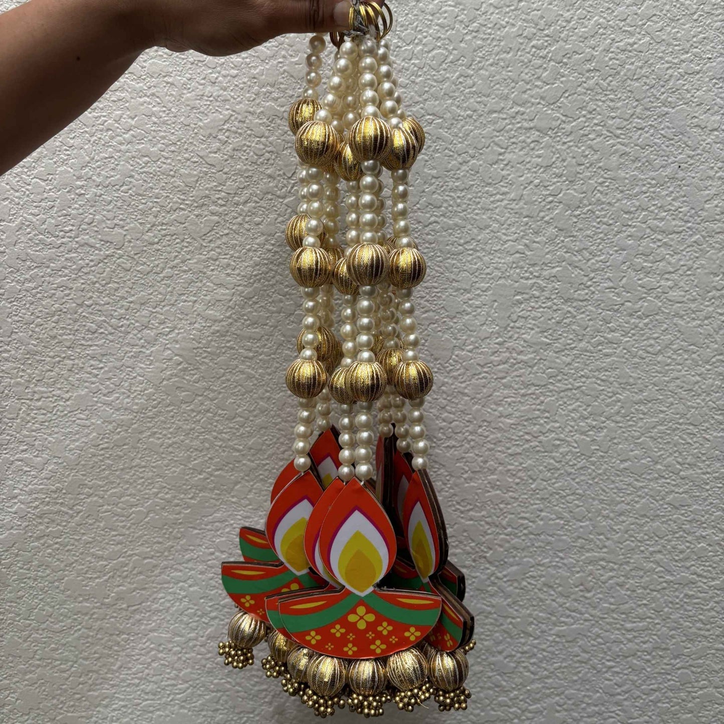 Long diya dangler with pearl and gold bead string, MDF diya cutout and gold jhumka bells at bottom