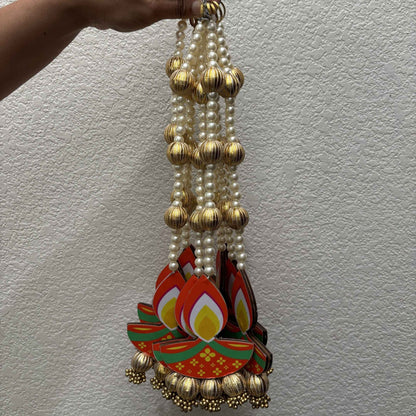 Long diya dangler with pearl and gold bead string, MDF diya cutout and gold jhumka bells at bottom