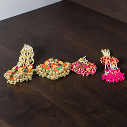 All 4 dangler designs flat lay on wood surface — long diya, short diya, long lotus, short lotus MDF