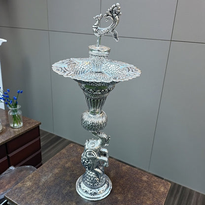 16-Inch Elephant Design Antique Silver Samai Oil Lamps with intricate design on a wooden surface.