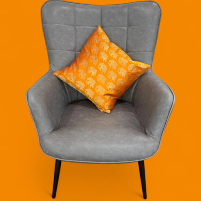 Gray chair with an orange pillow on an orange background