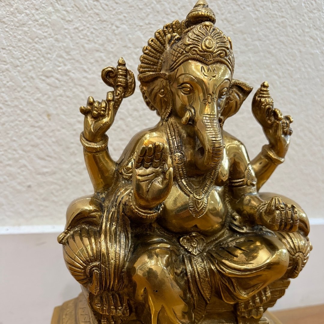 Close-up of finely engraved 9.5" Brass Ganesha statue showing intricate headdress and carved details