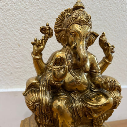 Close-up of finely engraved 9.5" Brass Ganesha statue showing intricate headdress and carved details