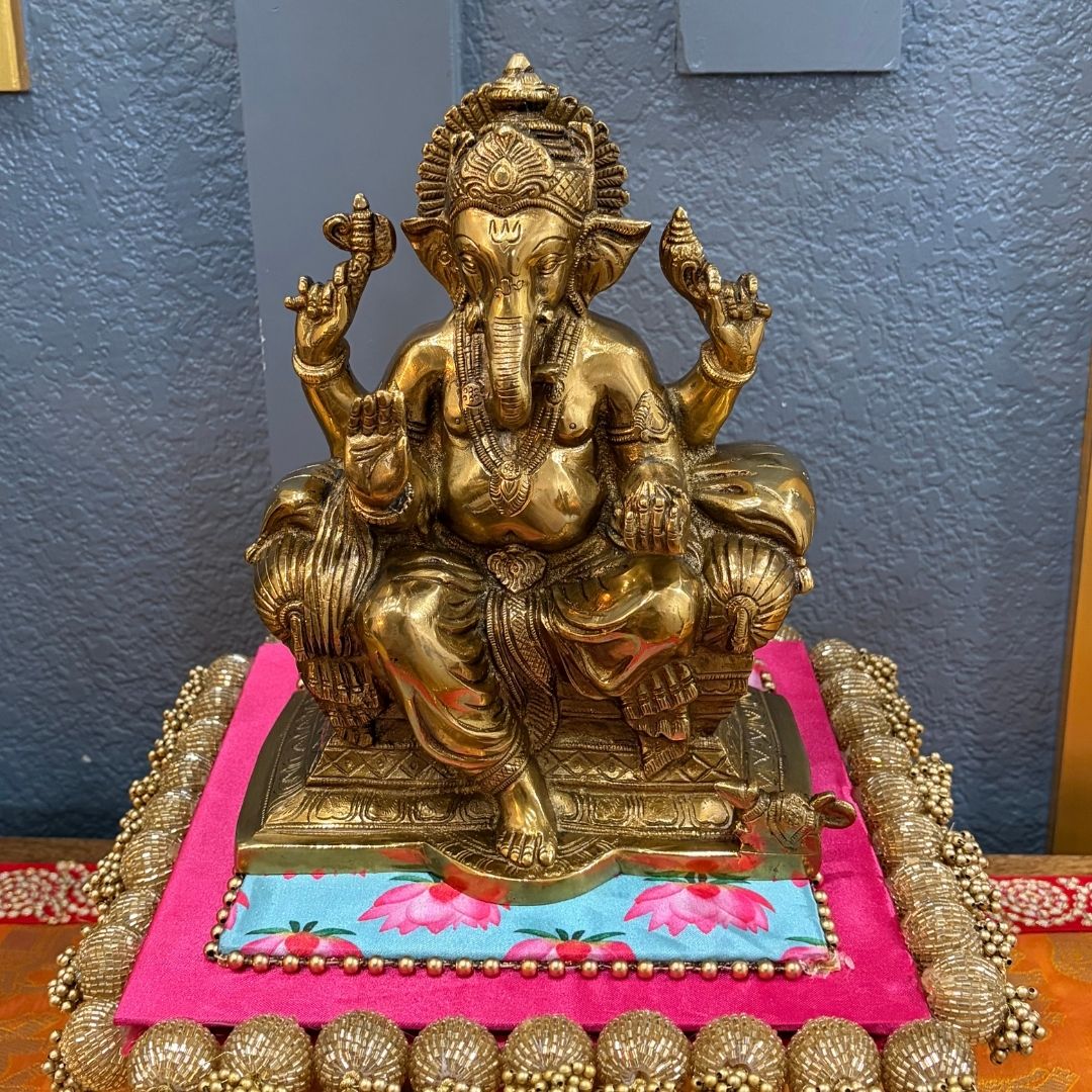 9.5" Brass Ganesha Statue antique gold finish on pink-blue platform — handcrafted Ganesh idol for home decor