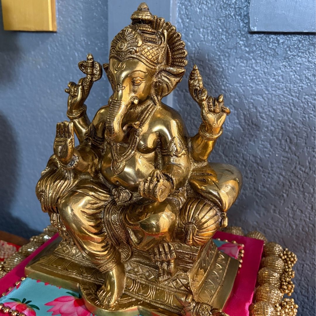Detailed shot of engraved patterns on antique gold Brass Ganesha statue — handcrafted Indian art