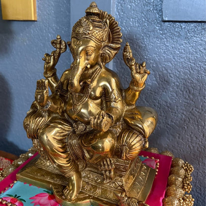 Detailed shot of engraved patterns on antique gold Brass Ganesha statue — handcrafted Indian art