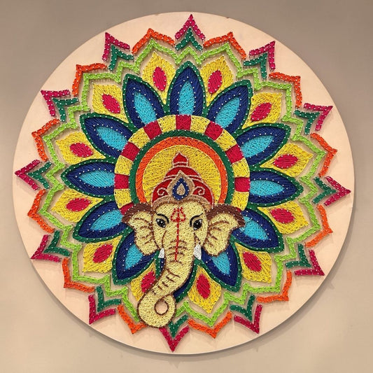 30-inch Ganesha string art wall decor featuring intricate colorful thread work and gold nails on a dark circular MDF board by Urli Utsav.