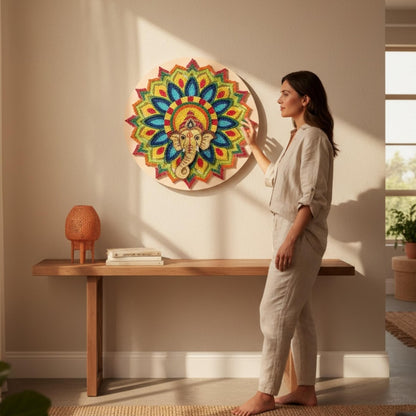 Woman standing in a room with a colorful mandala wall art piece.