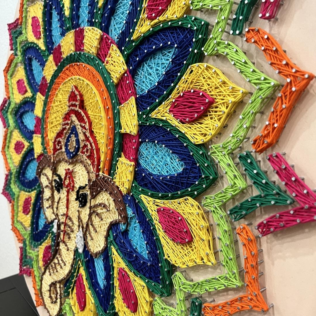 Side profile of 30-inch Ganesha nail and thread art showcasing the 3D textured effect and vibrant color transitions.