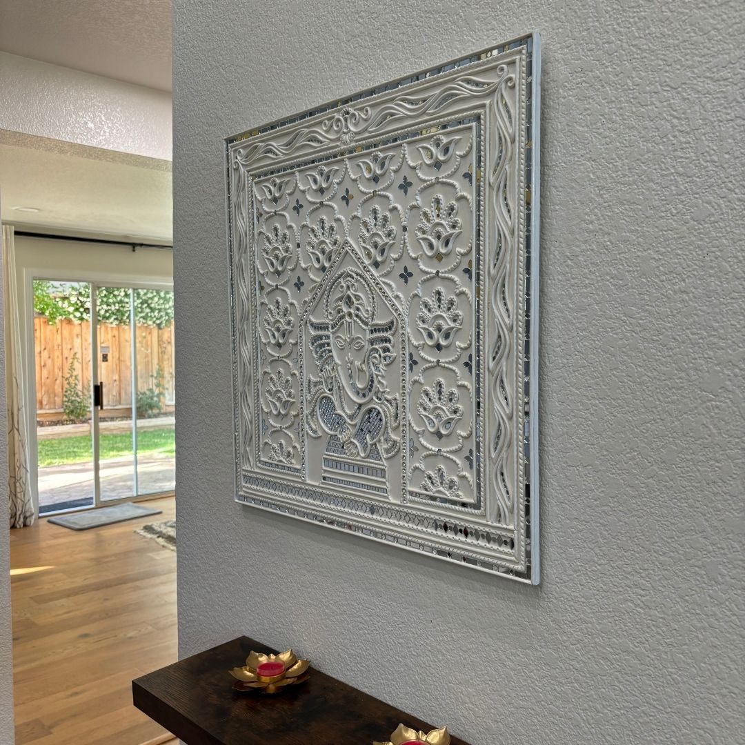 Decorative Ganesha Lippan wall art with intricate design on white wall