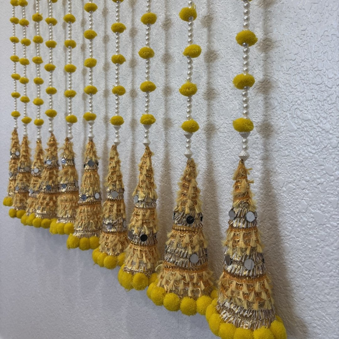 Close-up of gota cone garland with white pearl beads and silver mirror accents