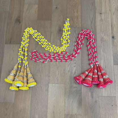 Yellow and red woolen bead garland flat lay – handmade Indian festive string decor