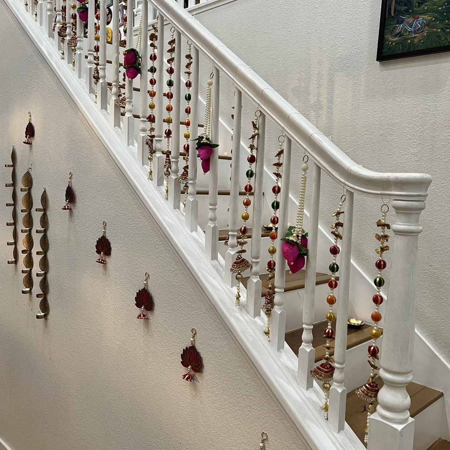 Urli Utsav multicolor gota pearl garlands decorating staircase railing for Diwali housewarming decor