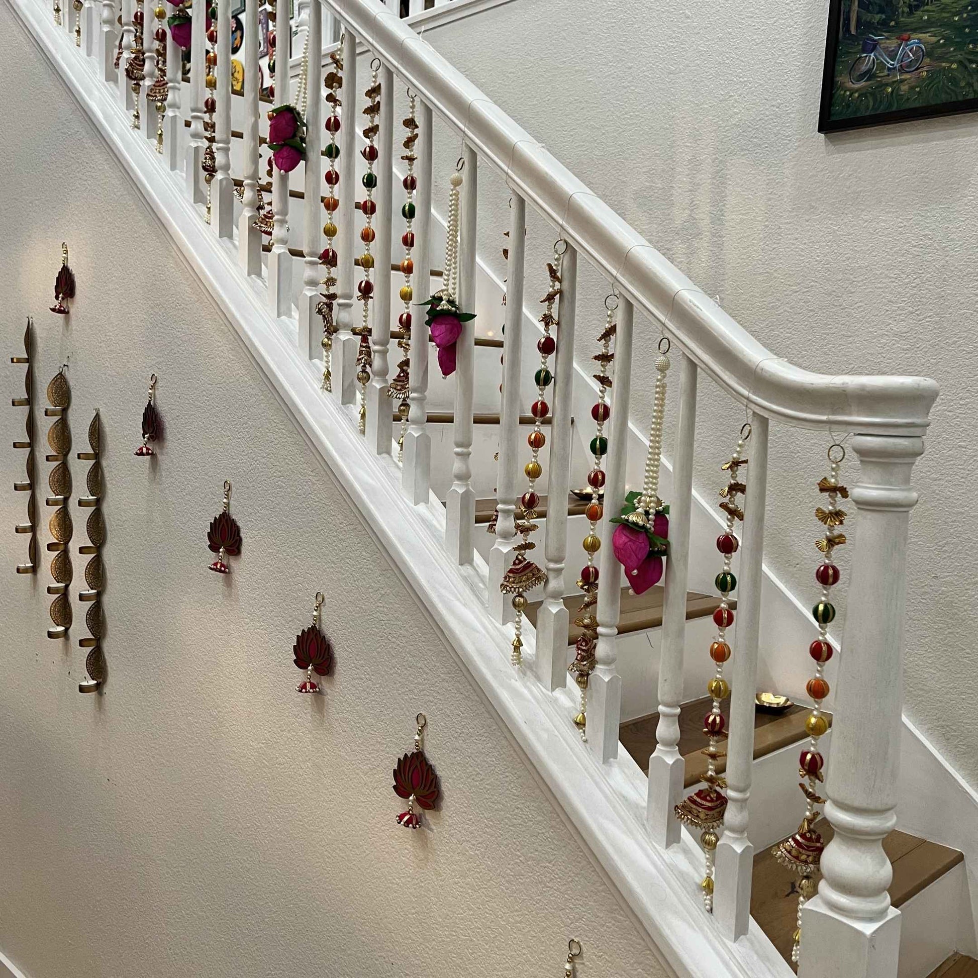 Urli Utsav multicolor gota pearl garlands decorating staircase railing for Diwali housewarming decor