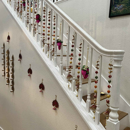 Urli Utsav multicolor gota pearl garlands decorating staircase railing for Diwali housewarming decor