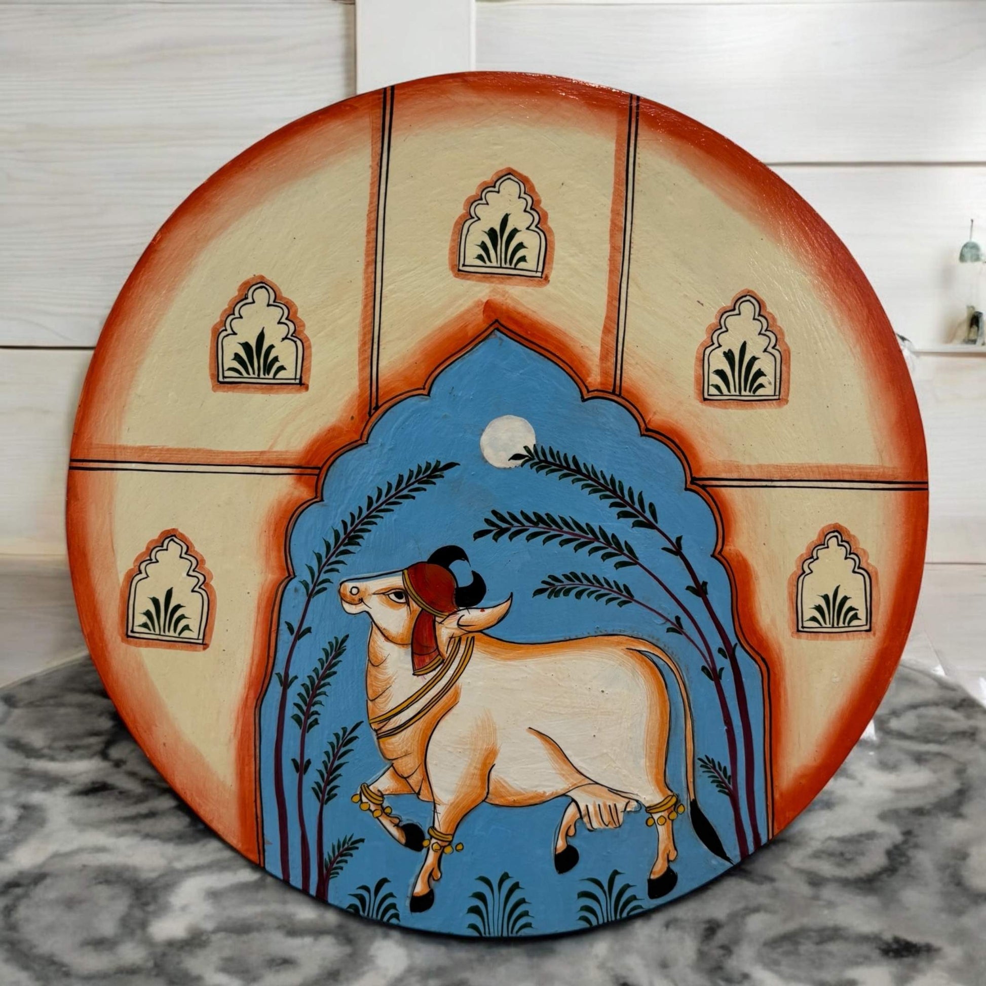 Handpainted Pichwai Cow wall plate with detailed cow and lotus motifs in bold colors, inspired by traditional Pichwai art