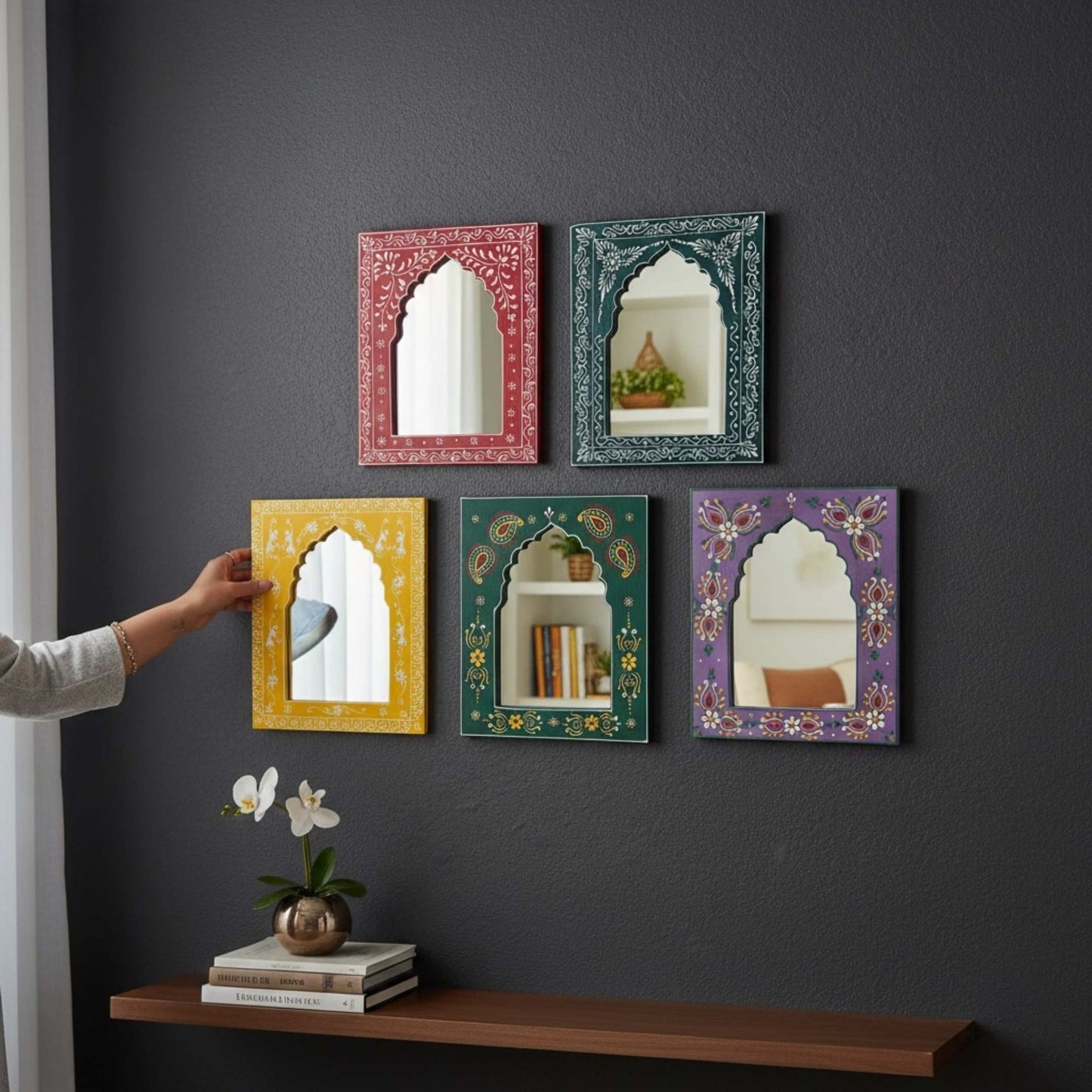 Decorative jharokha mirrors in various colors on a dark gray wall.