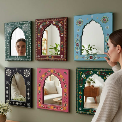 Woman looking at decorative jharokha mirrors by urli utsav decor