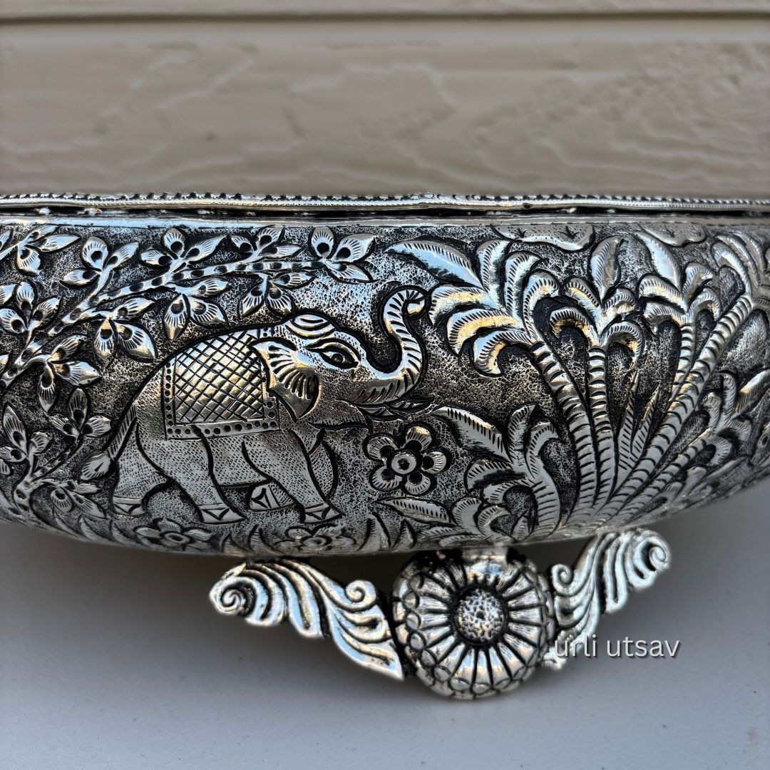 Close up of Jungle theme german silver urli bowl  intricate designs on a neutral background