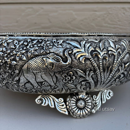 Close up of Jungle theme german silver urli bowl  intricate designs on a neutral background